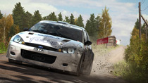 A Ford Focus RS Rally 2001 thunders down a hill in Germany, splattering mud in its wake.
