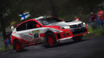 Cultures meet as a Japanese Subaru Impreza WRX STI 2011 speeds past Finnish spectators in Wales.
