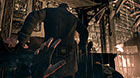 As he robs a corpse, this guard neglects to watch his own back.