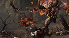 A Chaos Spawn, twisted enemy of all races in the Old World, lunges at a fallen Empire soldier.