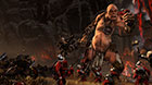 A Chaos Giant crushes a soldier of the Empire.